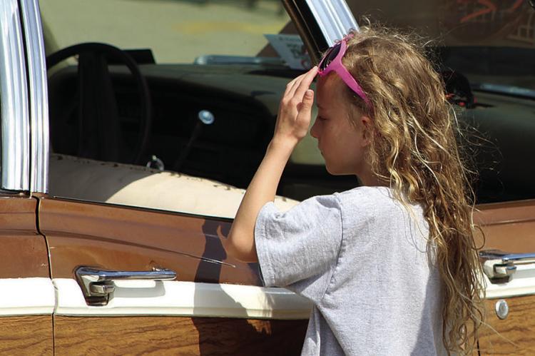 CURIOSITY GETS the best of Cate Kerste, as she examines the interior of a classic car during the car show, which raised funds for the class of 2027’s after-prom. SHARON DONAT | Staff