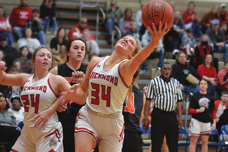 SENIOR EMMALEA KILPATRICK reaches for a second-half rebound while Richmond teammate Laney Moyer is ready to assist during the Spartans’ 39-32 victory over Oak Grove Jan. 28 at Richmond Middle School. SHAWN RONEY | Staff