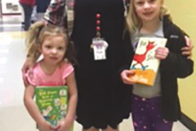 FIRST-GRADE teacher Shelbie Jones and daughters Olivia and Annabelle show off wacky socks.