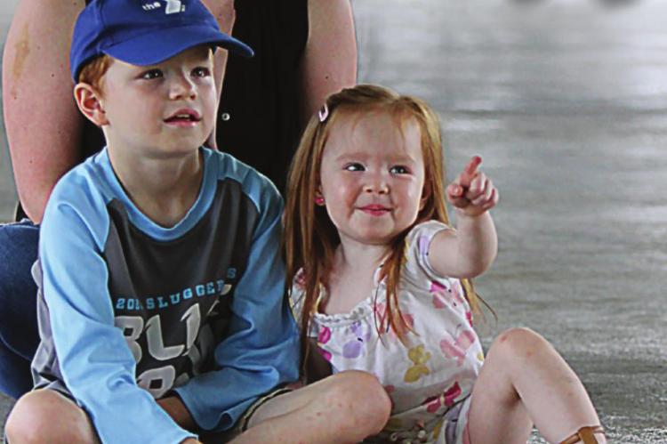 SITTING with their mother, Lauren Odil, are Ellis, 8; and Lark, 2. They watch “The Ogre’s Tail.” J.C. VENTIMIGLIA | Staff