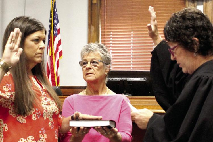 Heather Pugh (from left) is being sworn in by Laura Wrisinger and Ray County Judge Lori Baskins. Pugh took on a role with Missouri Developmental Disabilities Council last week. SOPHIA BALES | Staff