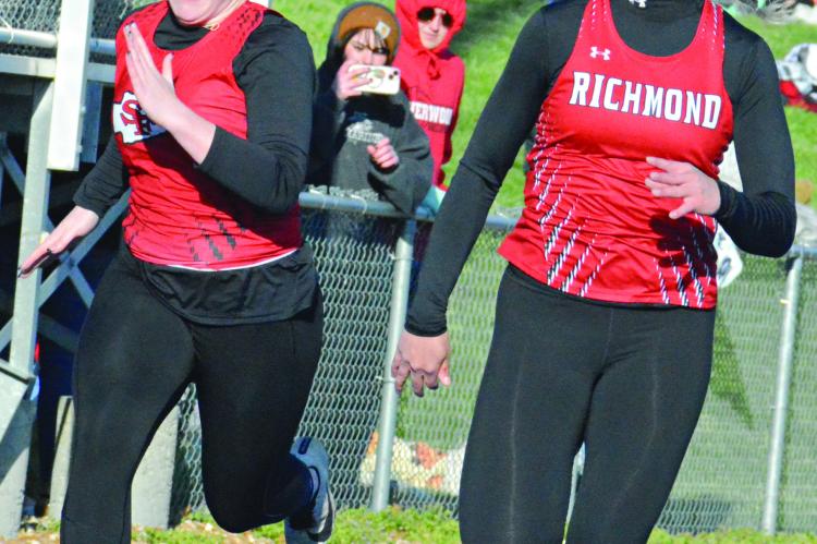 SENIOR KAYLEE PUGH (right) fights for position during the girls 100-meter dash. She wins the race in 13.62 seconds.