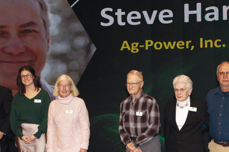 STEVE HAMM’S family accepts his John Deere Honorary Technician of the Year award during a ceremony recognizing technicians across the United States and Canada. Submitted