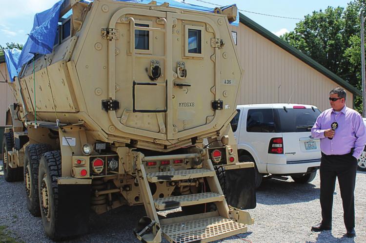 THIS ARMORED personnel carrier, called an MRAP, is described by sheriff’s detective Mark Crawford as being able to transport several law enforcers up close to a building where armed criminals might be holding hostages or into disaster areas. Secured from the U.S. Department of Defense at no cost to county taxpayers by Sgt. Brock Billings, the MRAP is on loan to the Ray County Sheriff’s Office. J.C. VENTIMIGLIA | Staff