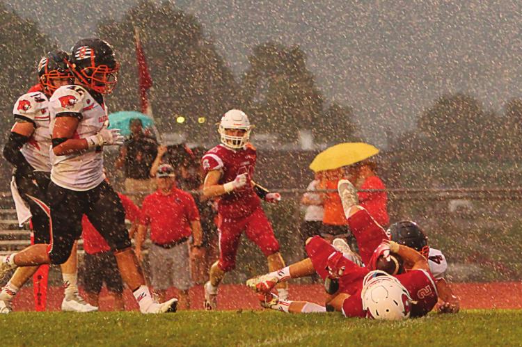 DURING A DOWNPOUR early in the second quarter, senior wide receiver Layne Cavanah pulls in a pass thrown from the 29-yard line by senior quarterback Keyshaun Elliott. Good for 18 yards, the play sets up Elliott’s first rushing touchdown against Oak Grove. J.C. VENTIMIGLIA | Staff