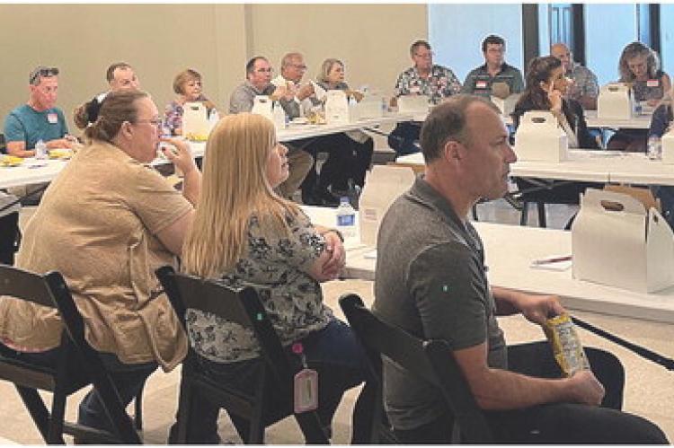 BUSINESS LEADERS gather July 27 at the chamber luncheon to hear analyses of the county from three state Department of Economic Development representatives and the opportunities available for growth. BRIAN RICE | Staff