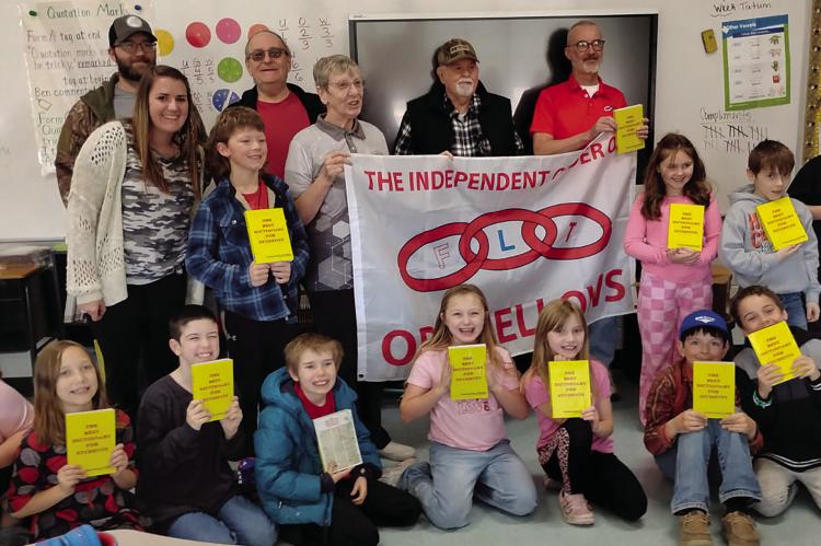 MEMBERS OF THE HIGGINSVILLE Odd Fellows donate dictionaries to third-grade students at Hardin-Central. Submitted