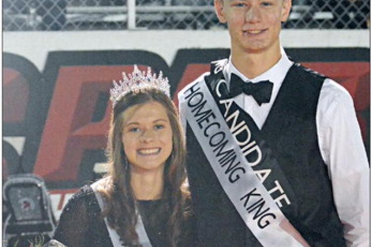 BASKING IN the glow of the backlighting from the press box and stadium lights, Grace Bozarth (left) and Gabe Baker beam after being crowned as Richmond’s homecoming royalty Sept. 22 at Spartan Stadium. SHAWN RONEY | Staff