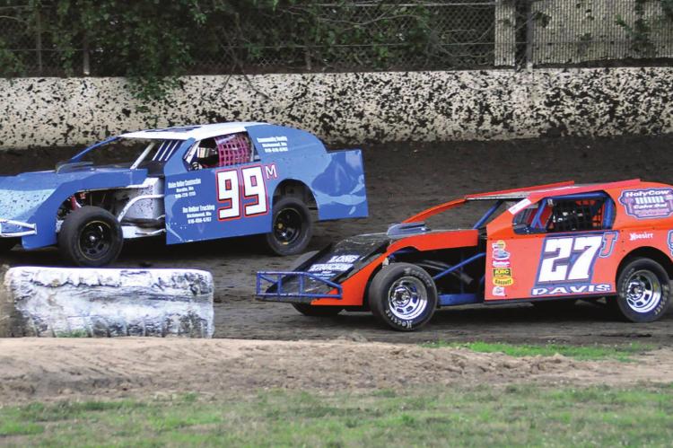 DRIVING THE 99M car, Richmond’s Skyler Nolker looks to get by Jeff Davis July 25 at Central Missouri Speedway. SHAWN RONEY | Staff