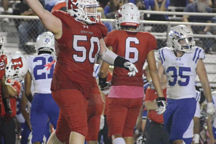 JOHN WEBER indicates it’s Richmond’s ball after he and his fellow Spartans make a fourth-down stop during the final quarter of Richmond’s Senior Night win over Holden.