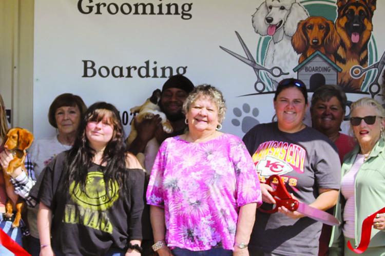 SHARON DONAT | Staff COMMUNITY MEMBERS join VIP Pet Care &amp; Services for a ribboncutting at its new location, 806 East Main Street.