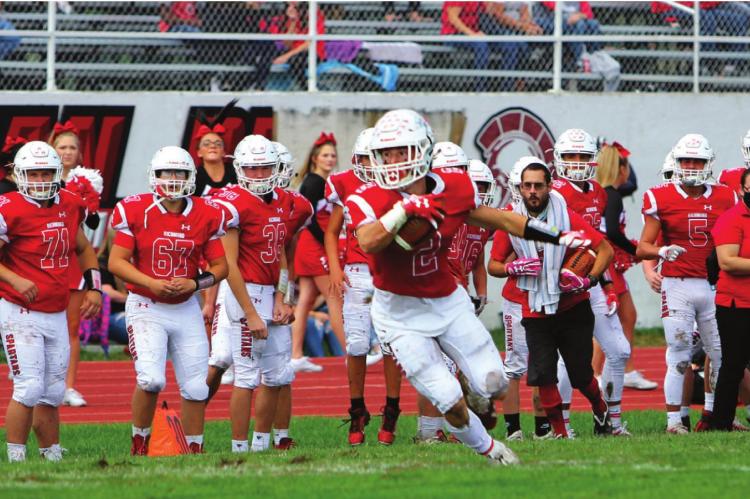 J.C. VENTIMIGLIA | Staff ON A SLOPPY FIELD at Richmond High School, junior wide receiver Layne Cavanah hauls in a pass from junior quarterback Keyshaun Elliott around Fulton’s 25-yard line, leading to the team’s first score in a 42-7 victory.