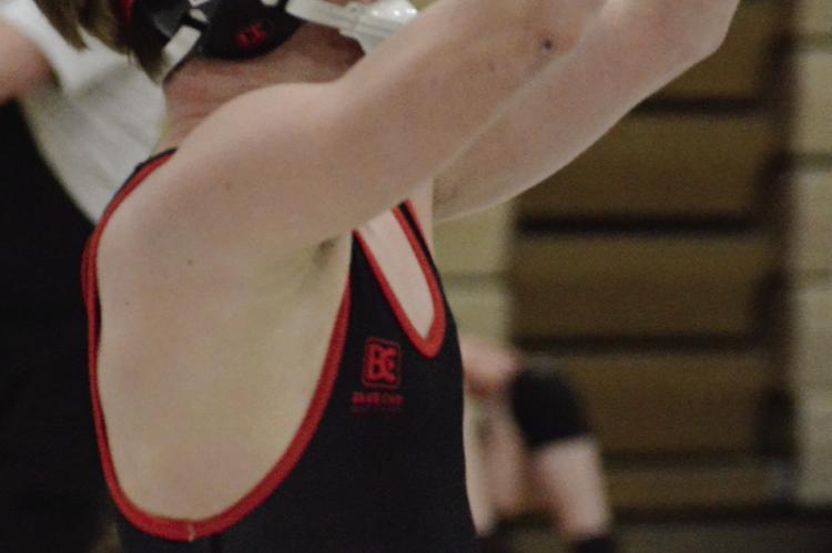 RICHMOND SOPHOMORE Raiden Sullivan raises his arms triumphantly after his win over Pleasant Hill’s Evan Neely at Class 2 District 4 boys wrestling competition. SHAWN RONEY | Staff