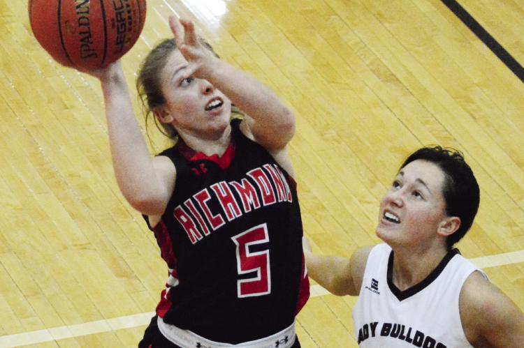 RICHMOND JUNIOR Laney Moyer attempts a first-half, one-handed jump shot in the paint as Gallatin senior Presley Wells attempts to guard her Jan. 13 in fifth-place tournament action at Lawson High School. SHAWN RONEY | Staff