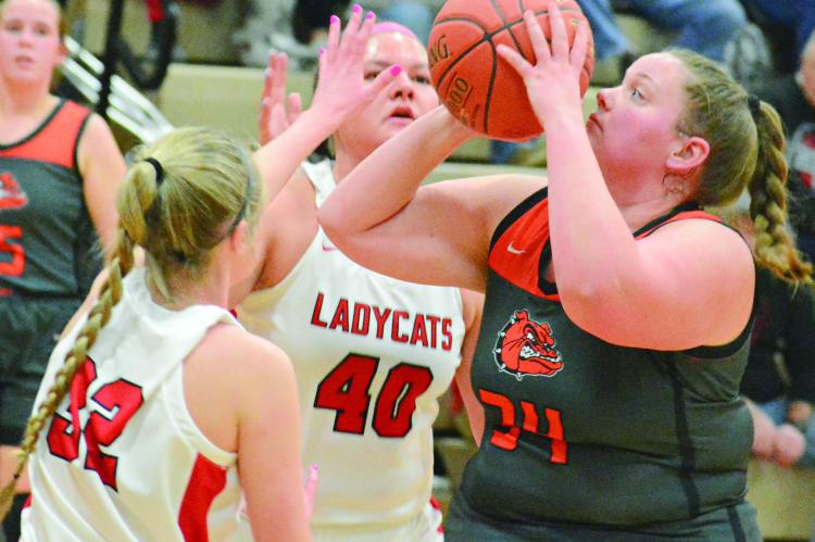 HANNAH FINLEY (right), a Hardin-Central junior, attempts a contested shot.