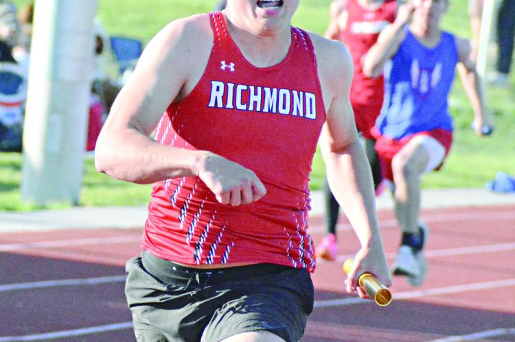 SENIOR ELI STEELE finishes off the varsity boys 400-meter relay Monday at the Missouri River Valley Conference East Division meet at Carrollton. SHAWN RONEY | Staff