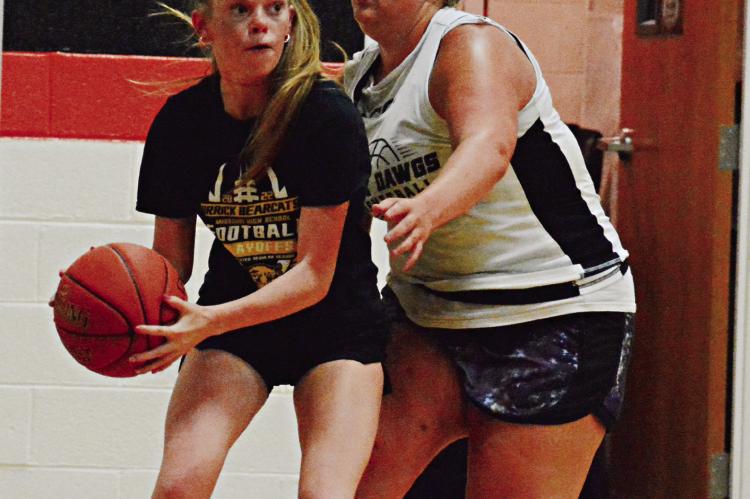 GUARDED BY Hardin-Central’s Hannah Finley, Orrick’s Addison Chapman eyes the court from the baseline June 22 at Hardin-Central. SHAWN RONEY | Staff