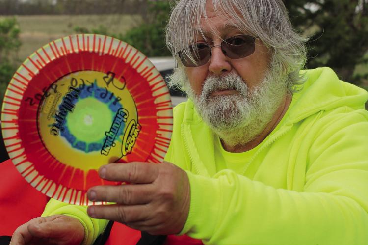 KNOXVILLE RESIDENT CHARLIE BAKER shows a disc used for disc golfing — a sport he enjoys in groups and alone. Baker is looking forward to making his hobbies into shared experiences with other disc golfers. SOPHIA BALES | Staff
