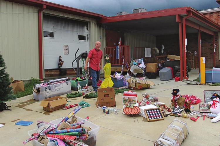SALVATION Army Store Director Phil Powers stands amid items that went through basement flooding from the fire hoses used to put out the building fire. The items, many in good shape, are marked down by 75%, he says. J.C. VENTIMIGLIA | Staff