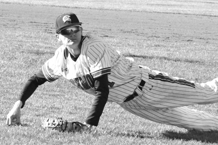 HUNTER MITCHELL looks to throw to first base after diving to field an infield blooper during Richmond’s April 4 varsity baseball meeting with Benton, a St. Joseph-based school, at Southview Park. SHAWN RONEY | Staff