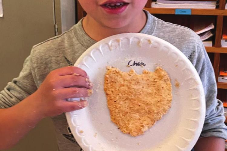 DEAR ELEMENTARY student Chase Racy shows off the particleboard he creates.
