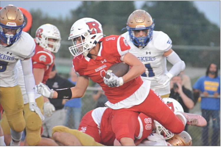 WITH THE football tucked under his left arm, first-year high schooler Dryden Hendrix rumbles for yardage during the first half of Richmond’s Sept. 22 homecoming meeting with Lafayette County of Higginsville. SHAWN RONEY | Staff