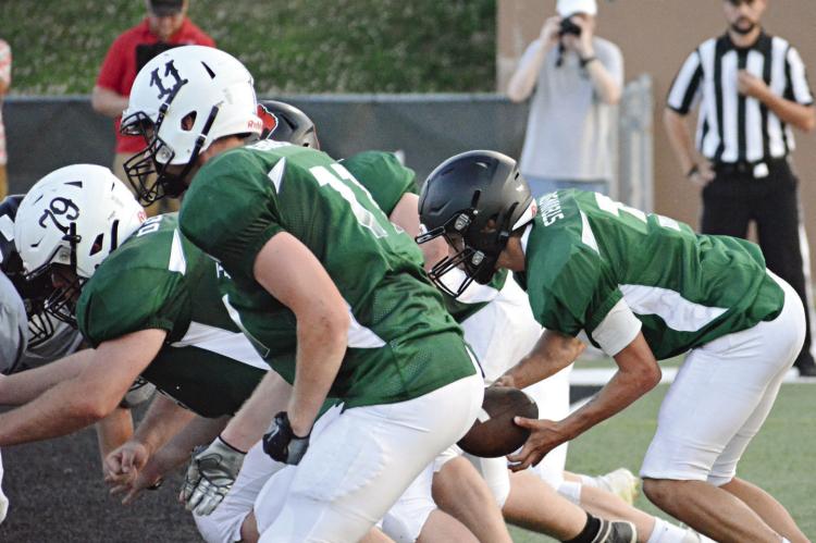 REPRESENTING NHC, J.W. Doyle (No. 79) and Kobe Gibson (No. 11) block for quarterback Zander Stevinson June 24 in all-star action in St. Joseph. SHAWN RONEY | Staff