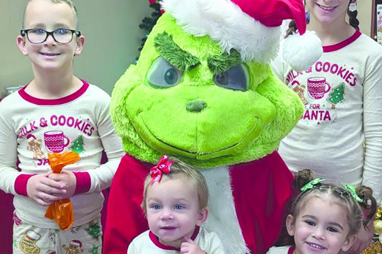 THE BARRON FAMILY kicks off the holiday season by visiting the Grinch at the Richmond Area Chamber of Commerce. Members of the Barron family include Lillian (clockwise from top right), Jordan, Elliot and Kayson. JAYNE TAYLOR | Submitted
