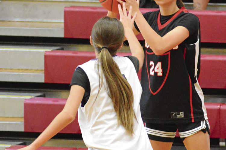 BRYLEE CASTILLEJA (right) looks to pass while closely guarded on the wing during Richmond’s girls basketball clash with Meadville in River Valley Shootout action. SHAWN RONEY | Staff