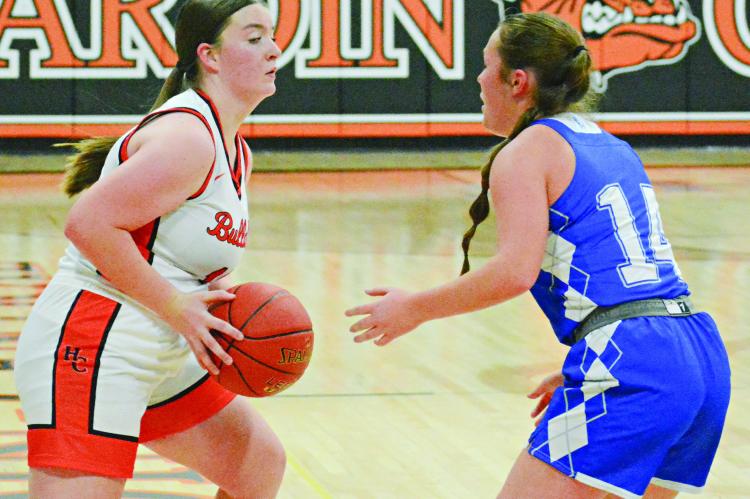 LILLY LYON (left) looks to pass for Hardin-Central while guarded by Tri-County’s Aliee Prescott. SHAWN RONEY | Staff