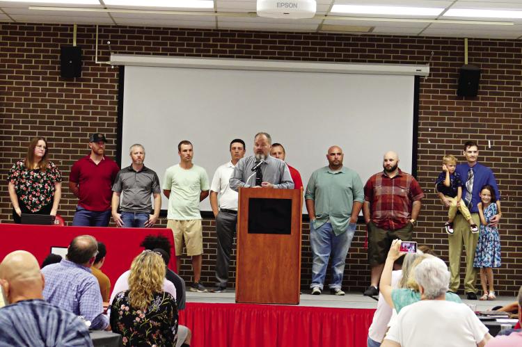 JOHN DANIELS speaks about coaching Richmond’s 2005 Class 1 state champion wrestling team as members of the squad, and a few family members of squad members, fill the stage behind him June 3 near the end of the Richmond High School Athletic Hall of Fame induction ceremony. ELIZABETH BARNT | Staff
