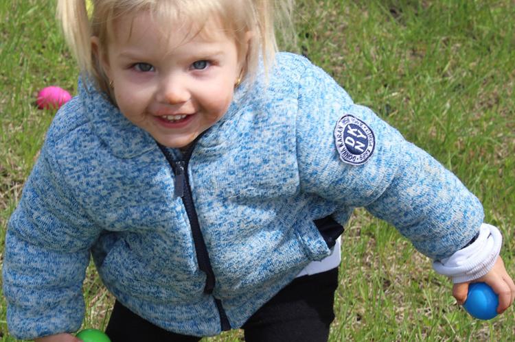 LONDON REYNOLDS collects as many eggs as she can hold. SHARON DONAT | Staff