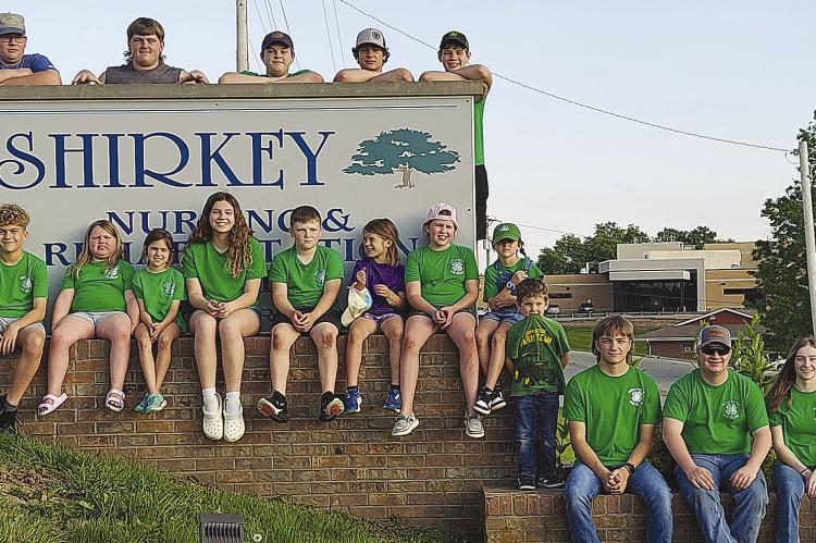 Millville 4-H beautify Shirkey Nursing and Rehabilitation Center in Richmond. Below several members plant flowers around a bird bath for seniors to enjoy when outside in the garden. Submitted