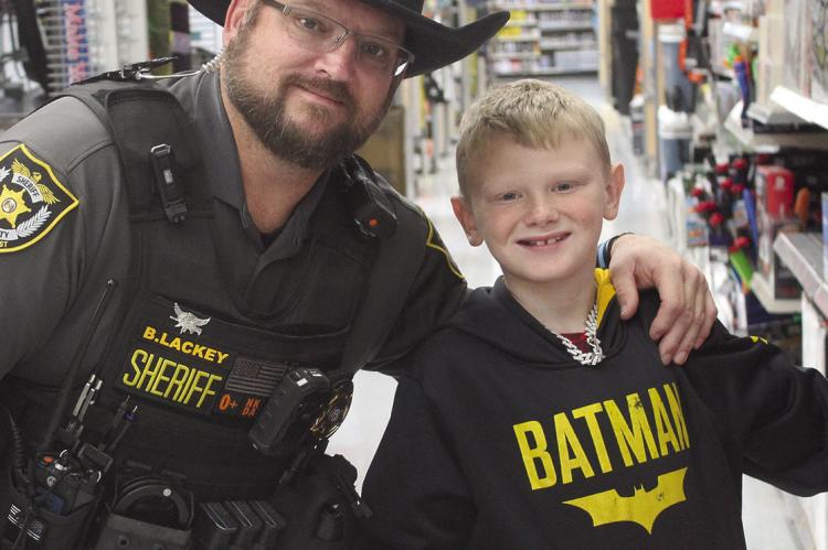 RCSD DEPUTY Brian Lackey (left) and Lelyn Hembree check out the nerf guns while participating in the Shop with a Sheriff event. MIRANDA JAMISON | Staff