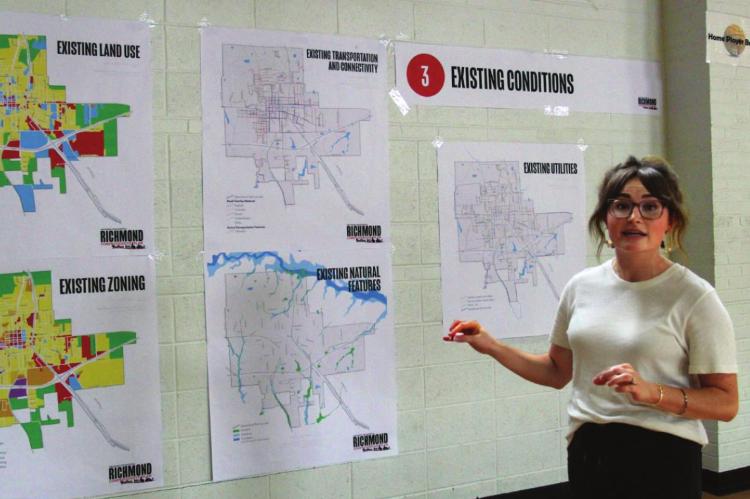 J.C. VENTIMIGLIA | Staff DURING THE CHARRETTE in June 2021, Olsson Studio project planner Taylor Plummer discusses various maps used to see where the city is and assist in where the city could go. ‘