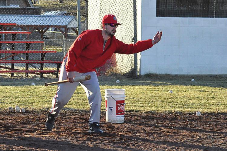 FIRST-SEASON Richmond varsity skipper Nick Persell rolls a baseball into the infield to drill the Spartans on bunt coverage and fielding during a practice in early March at Southview Park. SHAWN RONEY | Staff