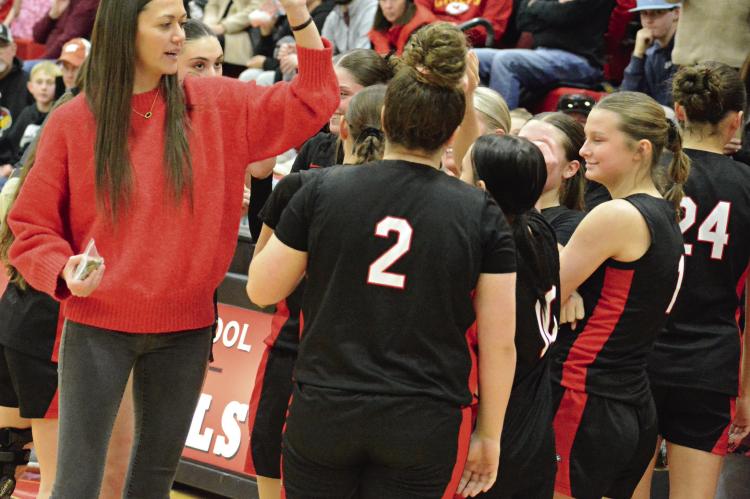 RICHMOND COACH Kaylee Vantrump (left) exchanges high fives with the Spartans after they win the girls portion of the Lawson Invitational Tournament title. SHAWN RONEY | Staff