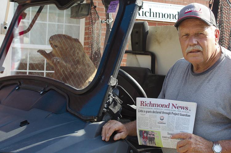 LARRY WILLIAMS and his travel companion, Luther, swing by to pick up a newspaper. SHARON DONAT | Staff