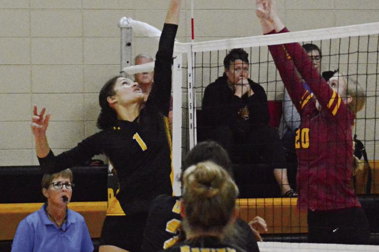 ORRICK SENIOR Anela Fletcher (No. 1) attempts to tip over Kansas City Lutheran’s Kate Mahnken recently in home varsity volleyball action. SHAWN RONEY | Staff