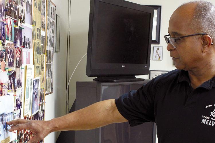 AS SENIOR WARTER Melvin Allen Jr. looks at old photos, he reminisces on quality community assurance. He points out pictures from past events when John W. Carter Lodge 180 members were more involved in the community. SOPHIA BALES | Staff