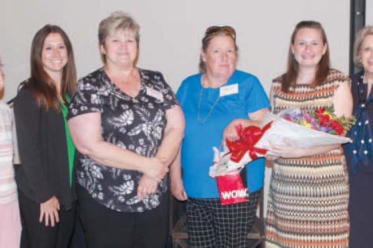 COURTNEY COLE accepts gifts from Renee Kellerman during the Richmond Area Chamber of Commerce Luncheon. Representing their businesses are June Harrison (from left), Donna Matthews, Katherine Boruch, Kellerman, Jayne Taylor, Cole, Stephanie Landwehr and Lauren O’Dell.