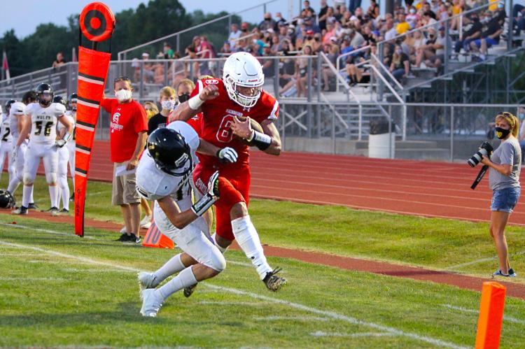 ON THE SOUTH SIDE of the Richmond field, near Lathrop’s fans in the stands, Richmond junior quarterback Keyshaun Elliott is harried by a defender who drives him out of bounds, but not before Elliott reaches the pylon for the score in the 44-6 Spartan victory Friday. Richmond’s players have a promising season in front of them, but word has come down that some Lathrop players may have COVID-19, forcing Richmond players this week to self-isolate.