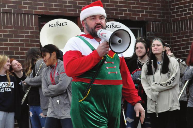 RICHMOND High School Principal Brandon Quick takes the bullhorn Monday to address the student body during an afternoon outdoor assembly. Quick praises the students for raising $8,000 for Raise the Roof, a campaign to assist needy district families. SHAWN RONEY | Staff