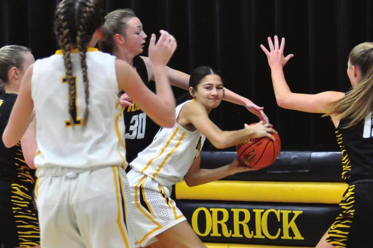 ANELA FLETCHER looks to work the ball out of a crowd under the bucket during the first half of Orrick’s Dec. 4 first-round tournament loss. SHAWN RONEY | Staff