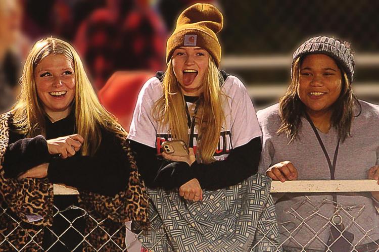 FANS ENCOURAGE the Richmond Spartans to fight onward to victory. Among those having fun at the Nov. 5 home playoff game are, from left, Emily Duncan, 15; Emma Craig, 16; and Tiara Smith, 15. J.C. VENTIMIGLIA | Staff