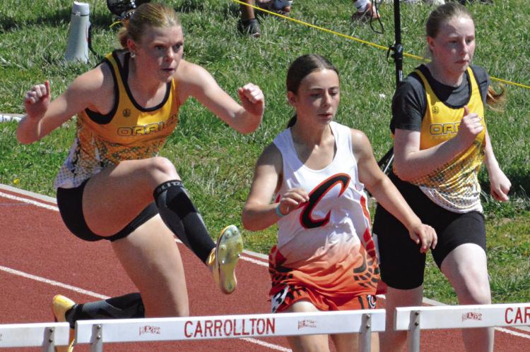 ADDISON CHAPMAN (left) fights for the lead in the girls 100-meter high hurdles at Class 1 District 4 competition. Also shown is Orrick teammate Natalie Cox (right). SHAWN RONEY | Staff