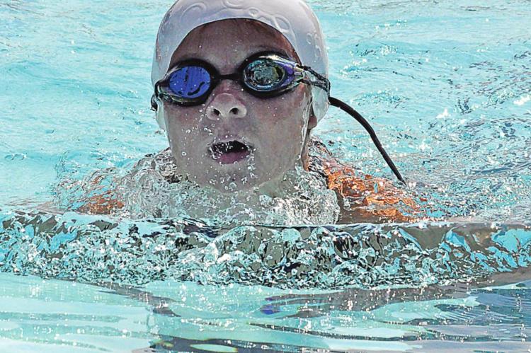 ARIEL LEE helps the Dolphins bring home a meet victory in their season finale July 17 at Southview Pool in Richmond. SHAWN RONEY | Staff