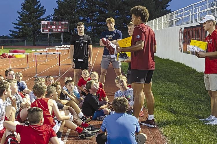 CAMP ATTENDEES listen to the advice given about football and life from local college students. Submitted