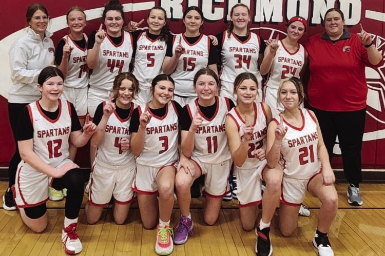 MEMBERS OF THE Richmond Middle School girls basketball team flash the “No. 1” sign after winning the Missouri River Valley Conference-East Division Tournament. Shown are Taylin Jennings (front row, from left), Jadyn Schmidt, Harper Hockemeier, Emmie Mueller, Kayton Arnold and Kaeleigh Damron. Back row: assistant coach Megan Baker, Eva Moyer, Olivia McCroskie, Madison Shroyer, Izzy Hash, Sydney Easton, London Calvert, and head coach Meg Blankenship. STACI MADDUX | Submitted