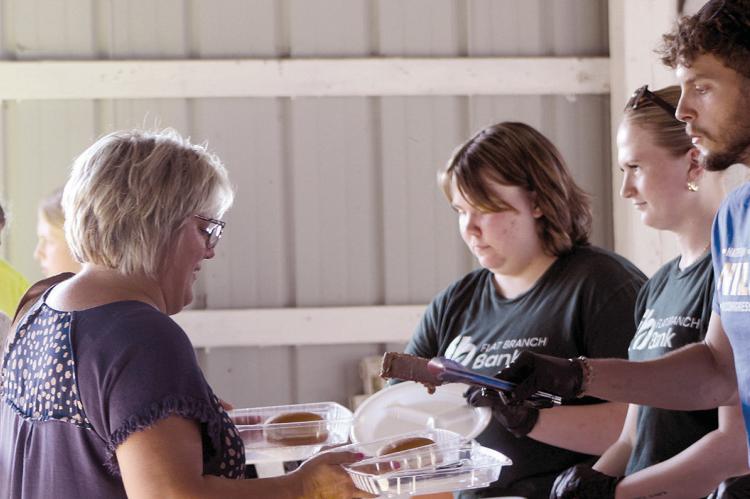 VOLUNTEERS SERVE FARM families a meal during the Farmers Appreciation Dinner.